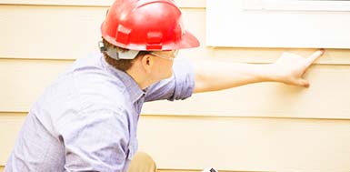 A man performing a Physical Home Defense home security check